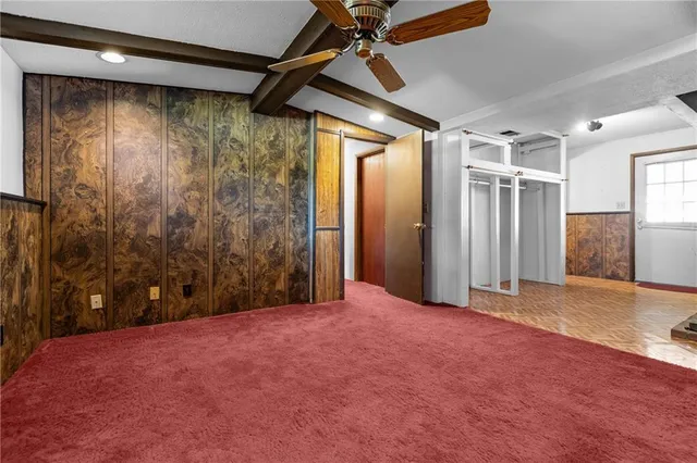 a view of empty room with wooden walls