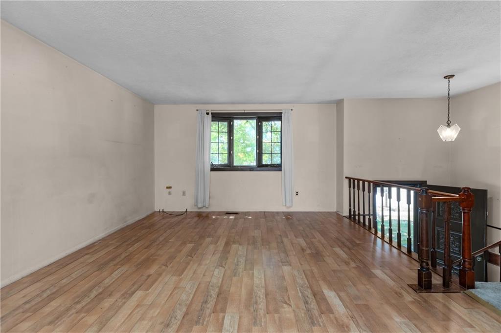 300 Moon Ridge Drive Freedom, PA 15042 - Photo 7 of 32 a view of an empty room with wooden floor and a window