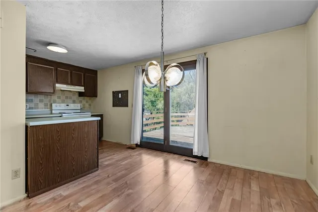 a view of kitchen with granite countertop cabinets and wooden floor