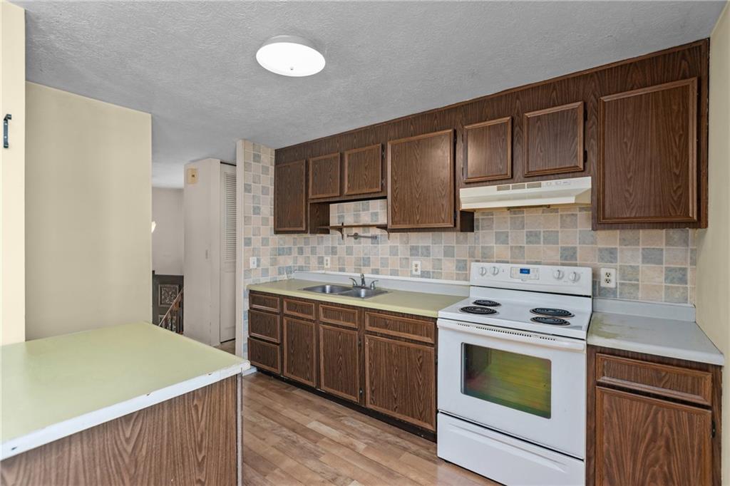 300 Moon Ridge Drive Freedom, PA 15042 - Photo 10 of 32 a kitchen with a sink stove top oven and cabinets