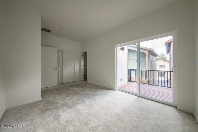 a view of an empty room with a balcony