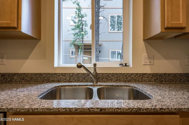 a kitchen with sink and window