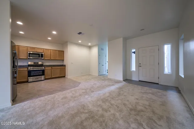 a view of kitchen with kitchen island and stainless steel appliances