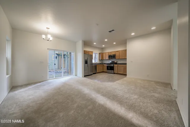 a view of kitchen with furniture and a refrigerator