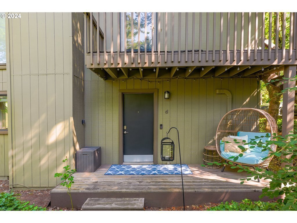 7702 Southwest Barnes Road, Unit D Portland, OR 97225 - Photo 1 of 24 a view of a door and chair in wooden floor