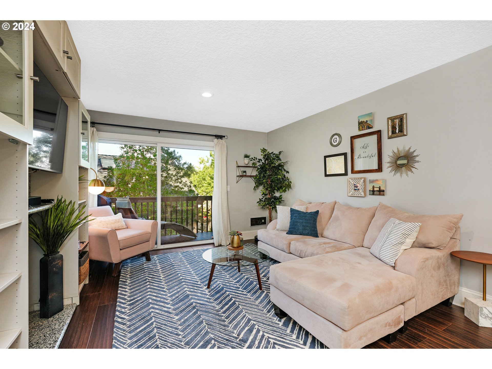 7702 Southwest Barnes Road, Unit D Portland, OR 97225 - Photo 2 of 24 a living room with furniture and a large window
