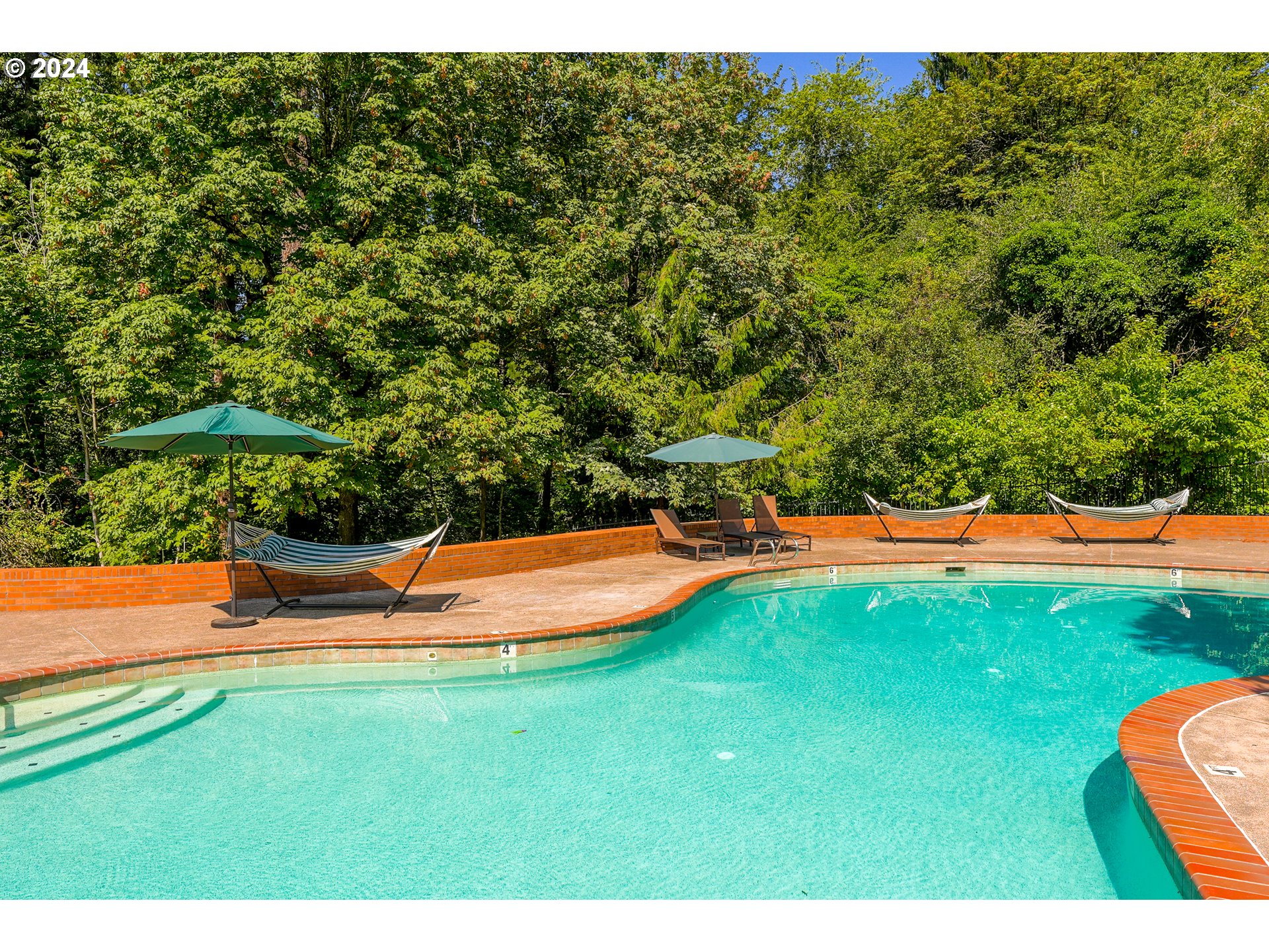 7702 Southwest Barnes Road, Unit D Portland, OR 97225 - Photo 21 of 24 a view of a swimming pool with an outdoor seating and a yard