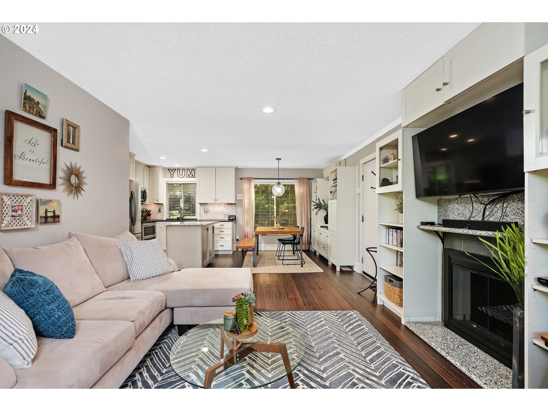 7702 Southwest Barnes Road, Unit D Portland, OR 97225 - Photo 3 of 24 a living room with furniture and a flat screen tv