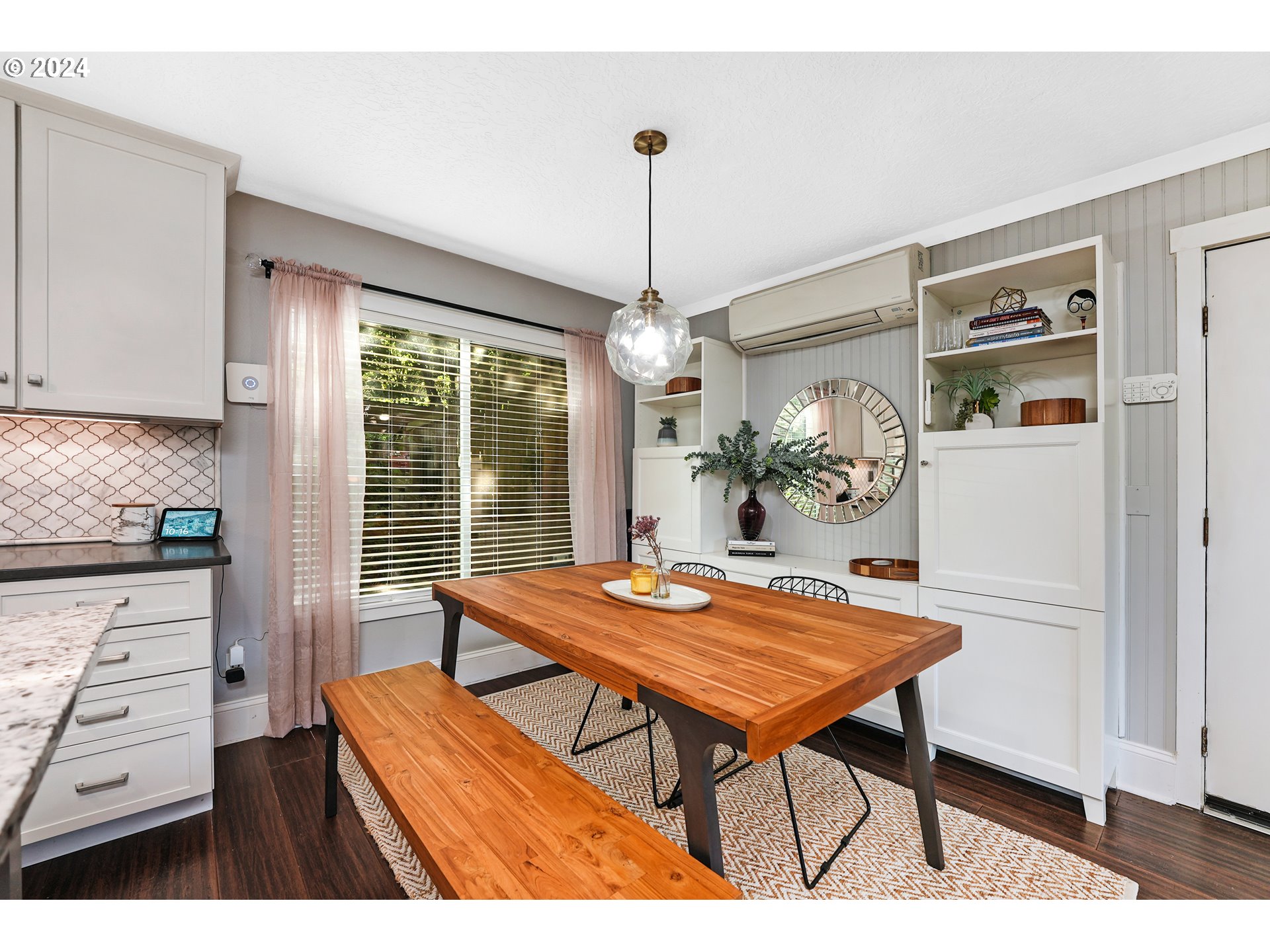 7702 Southwest Barnes Road, Unit D Portland, OR 97225 - Photo 5 of 24 a dining room with a table chairs and kitchen view