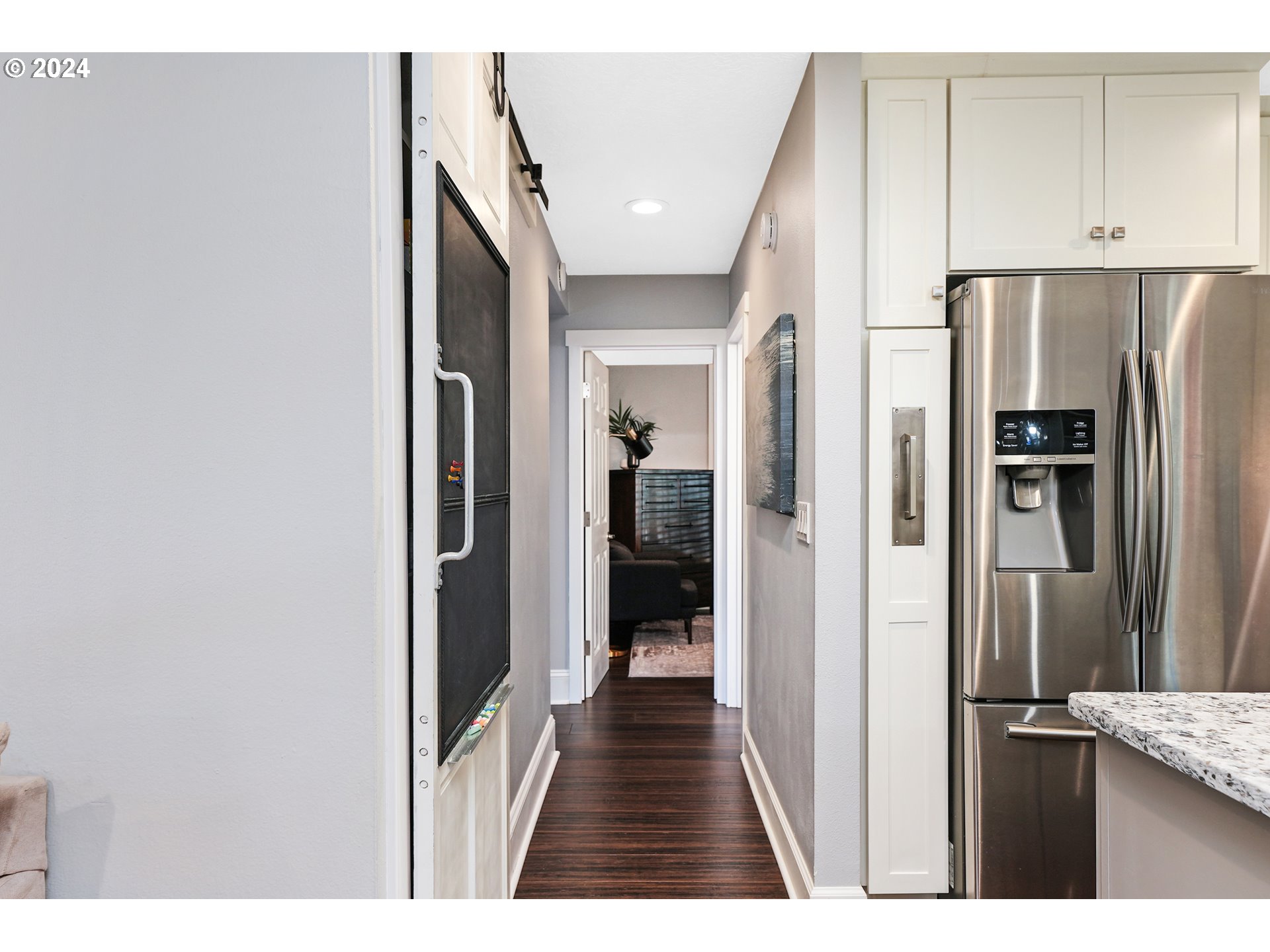 7702 Southwest Barnes Road, Unit D Portland, OR 97225 - Photo 8 of 24 a view of a kitchen from the hallway