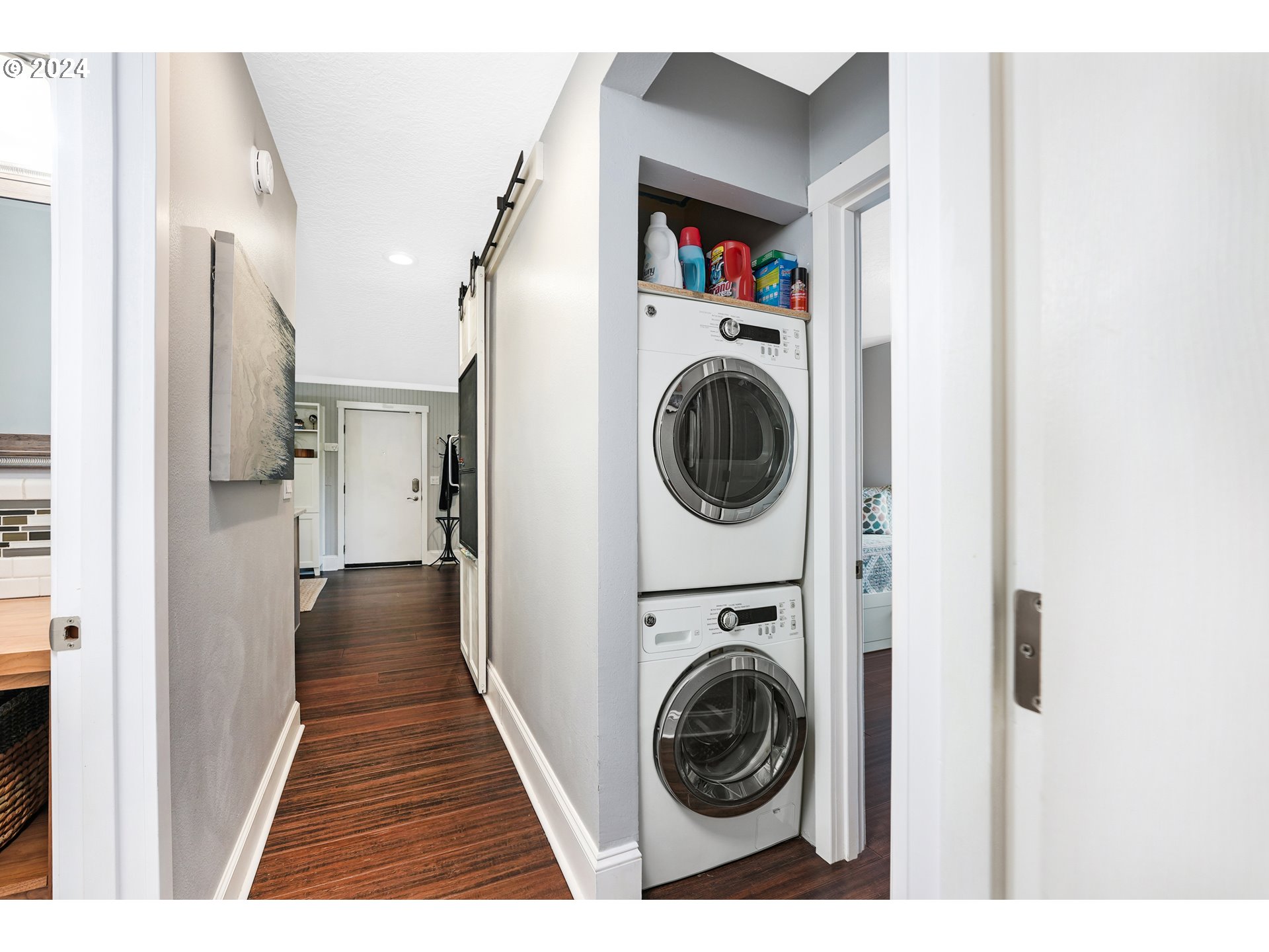 7702 Southwest Barnes Road, Unit D Portland, OR 97225 - Photo 10 of 24 a view of a hallway with washer and dryer