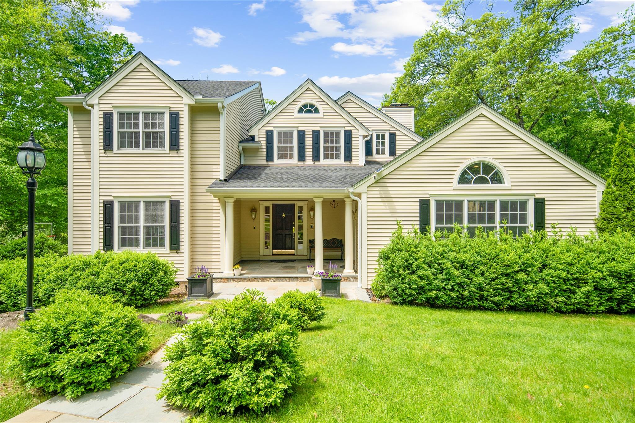 42 Chestnut Ridge Road Armonk, NY 10504 - Photo 1 of 1 a front view of a house with garden