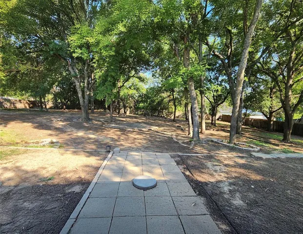 a view of a swimming pool and trees in the background