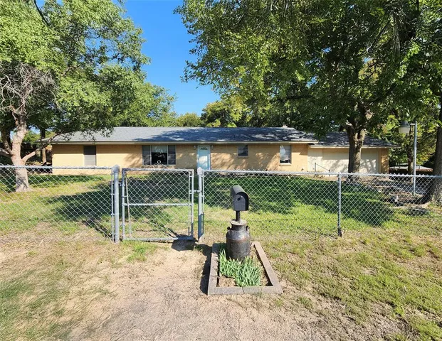 a view of a house with backyard and a patio
