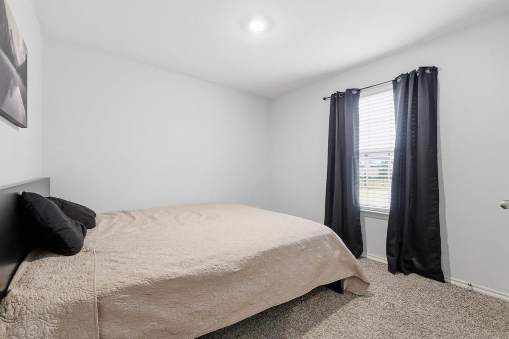 2416 Wildhaven Road Crandall, TX 75114 - Photo 20 of 35 a bedroom with a bed and a window