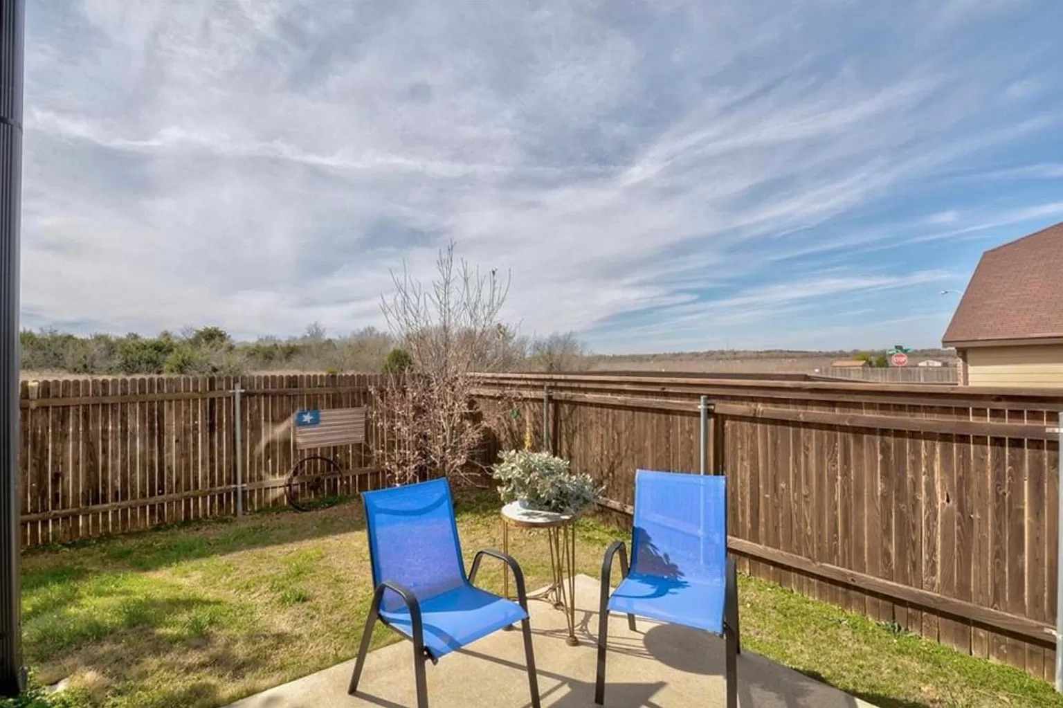 9016 Ridgewell Road Austin, TX 78747 - Photo 25 of 30 Relax on the concrete patio, enjoying the privacy of a wood fenced yard.