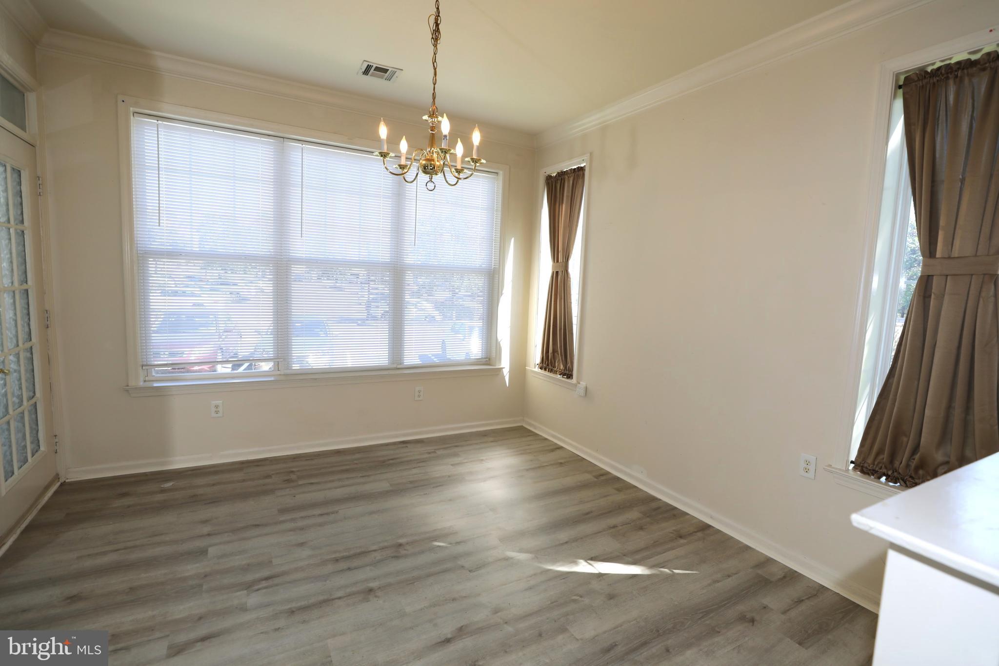 611 Masterson Court Ewing, NJ 08618 - Photo 11 of 38 a view of an empty room with wooden floor and a window
