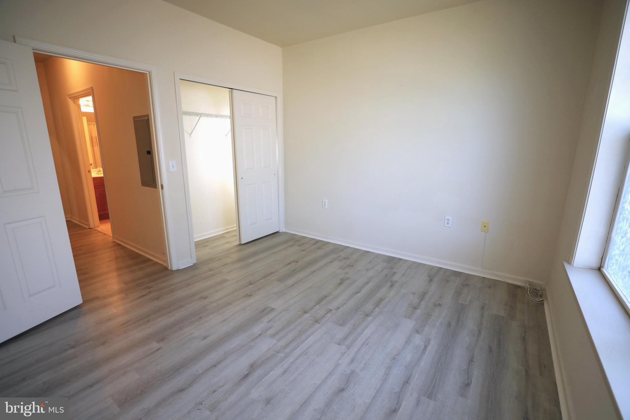 611 Masterson Court Ewing, NJ 08618 - Photo 30 of 38 an empty room with wooden floor and mirror