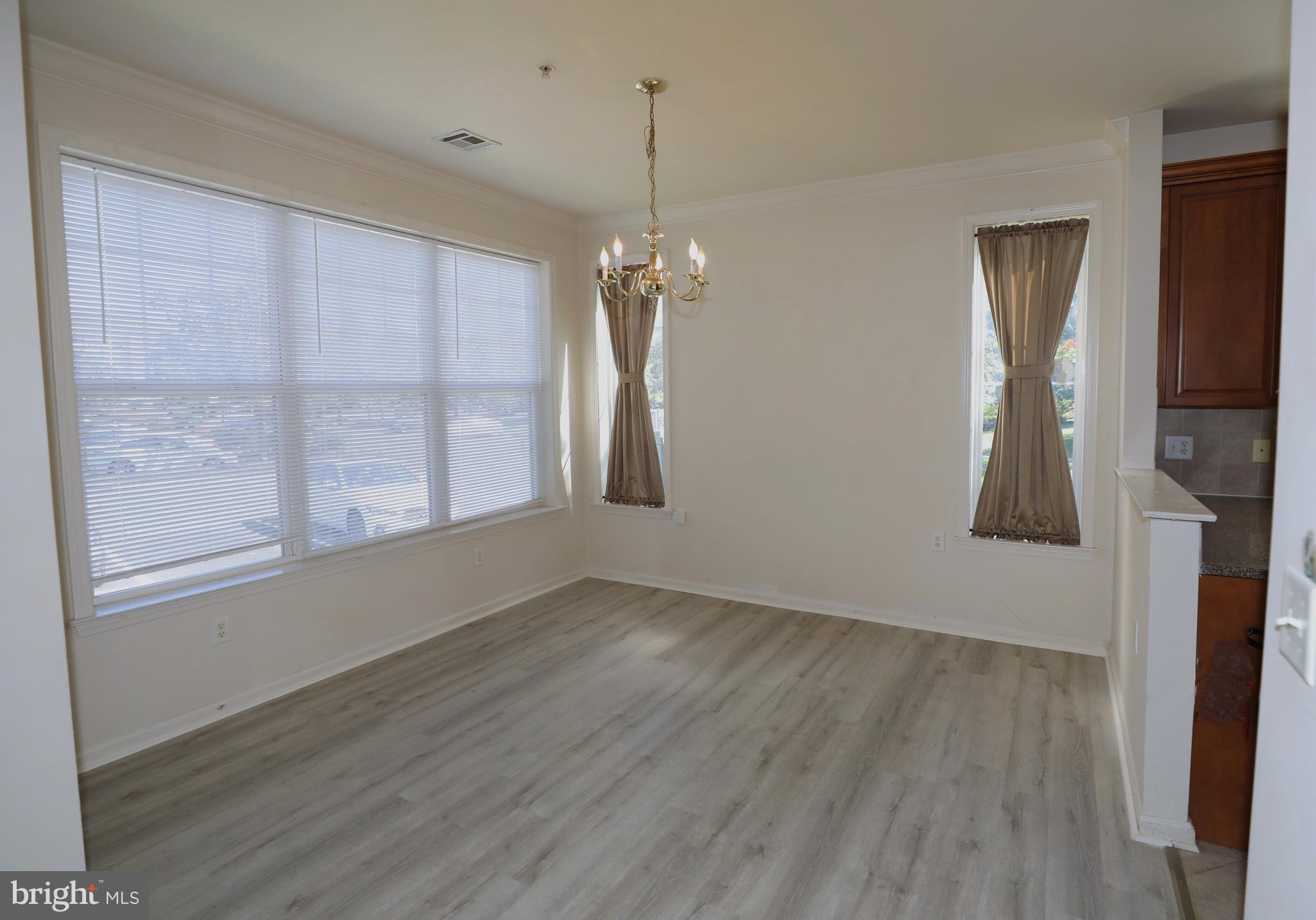 611 Masterson Court Ewing, NJ 08618 - Photo 31 of 38 wooden floor in an empty room with a window