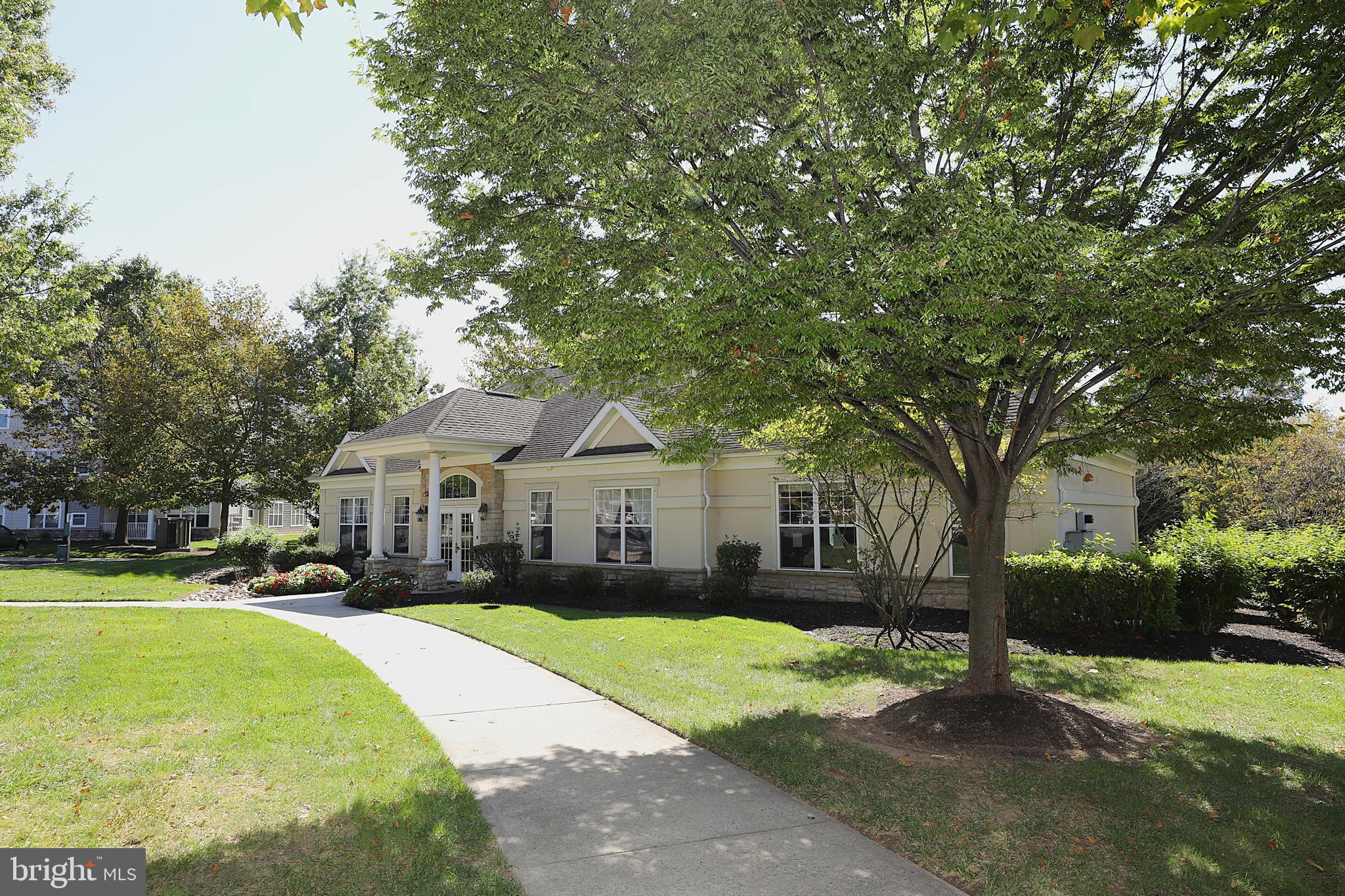 611 Masterson Court Ewing, NJ 08618 - Photo 36 of 38 a front view of a house with a garden and trees