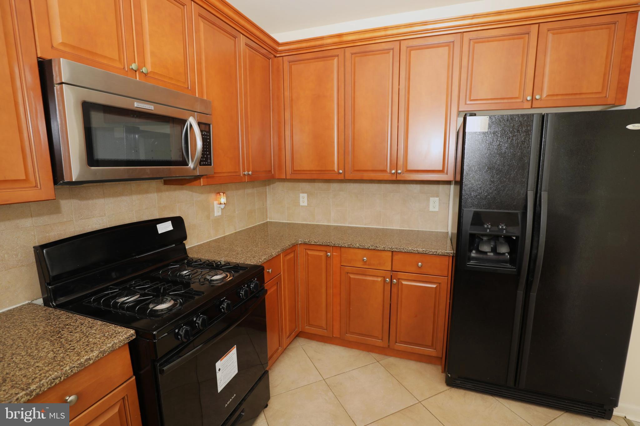 611 Masterson Court Ewing, NJ 08618 - Photo 10 of 38 a kitchen with stainless steel appliances granite countertop a refrigerator stove and microwave
