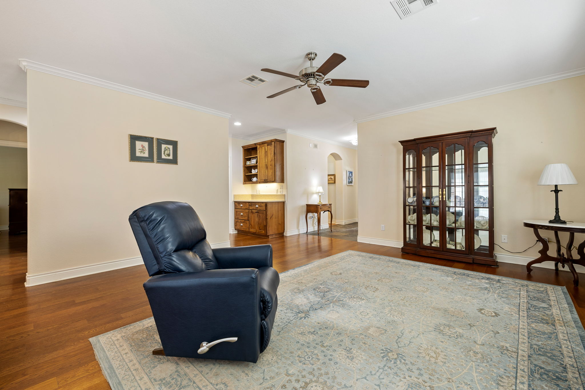 5201 Big Spring Street Georgetown, TX 78633 - Photo 9 of 26 Sitting room featuring arched walkways, dark wood-style flooring, ceiling fan, and ornamental molding