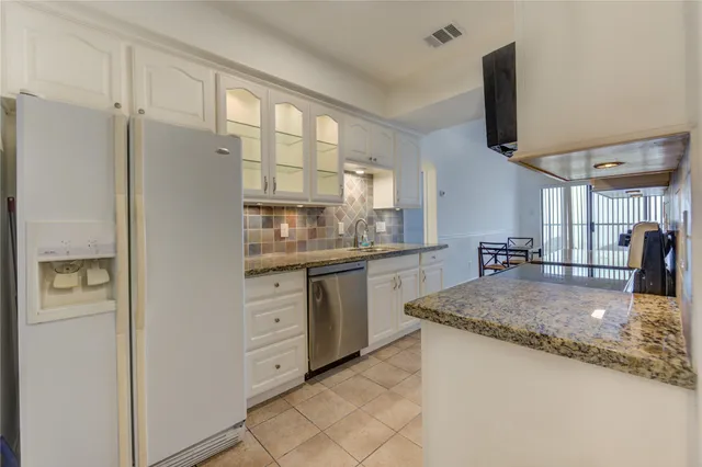a kitchen with stainless steel appliances granite countertop a stove and a refrigerator