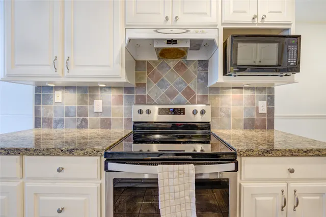a kitchen with granite countertop a sink and a window