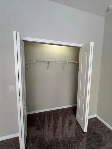 a spacious bathroom with a double vanity sink a mirror and a shower