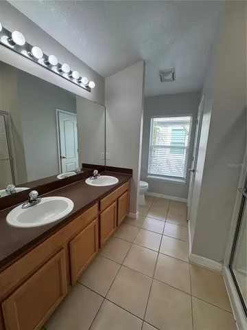 a bathroom with a sink double vanity and a mirror