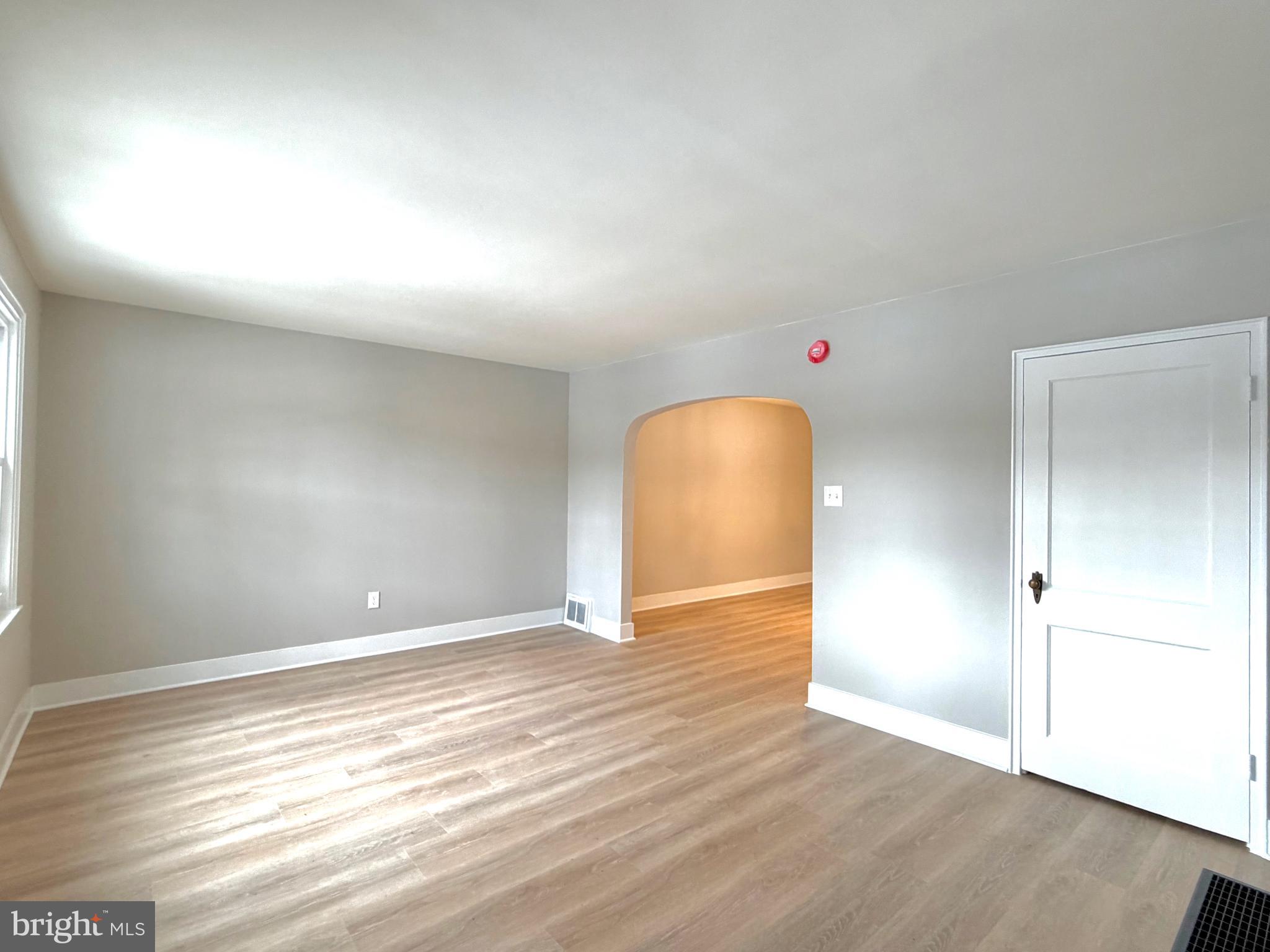 244 Sycamore Road Reading, PA 19611 - Photo 4 of 27 an empty room with wooden floor and windows