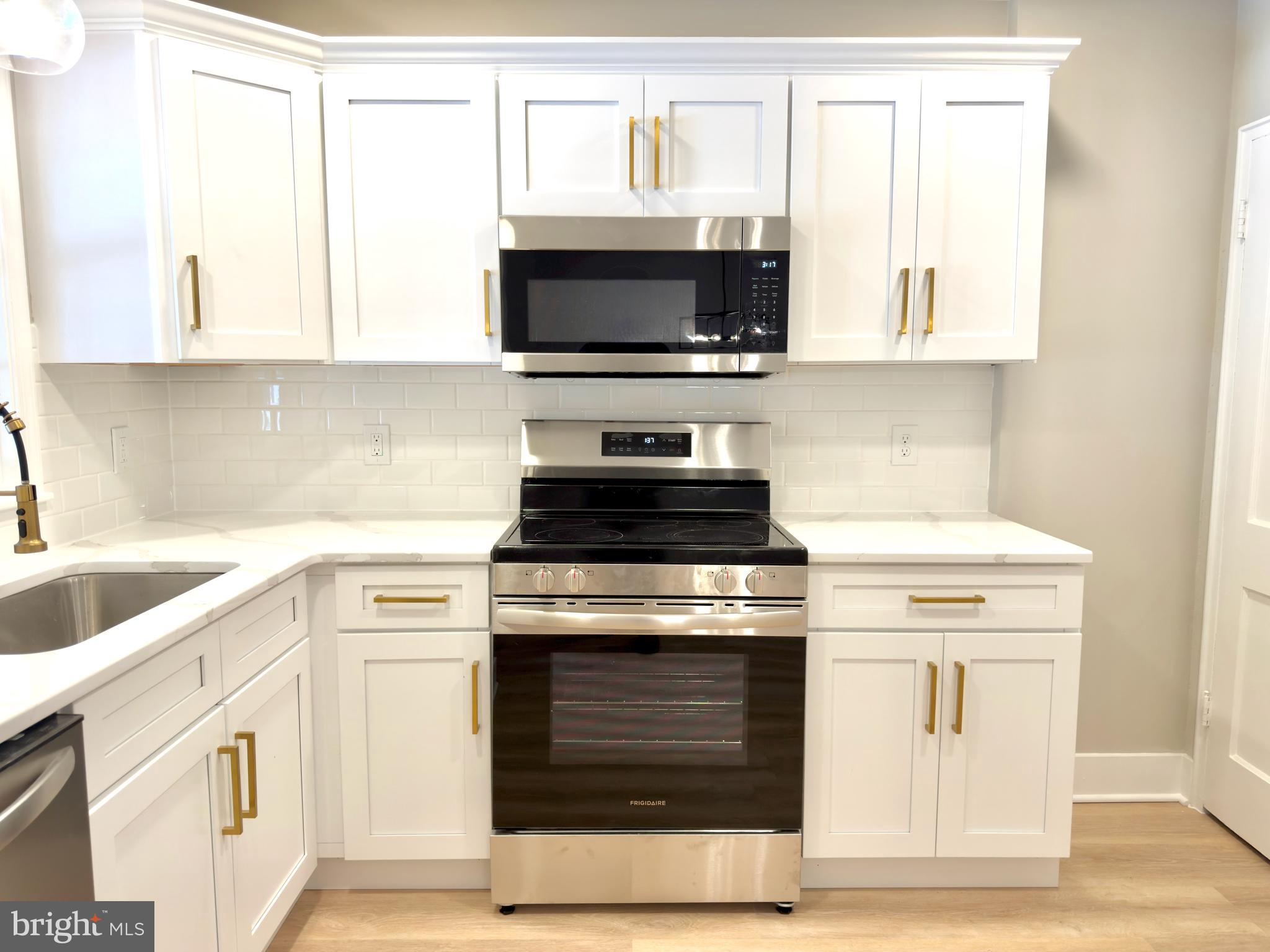 244 Sycamore Road Reading, PA 19611 - Photo 8 of 27 a kitchen with stainless steel appliances granite countertop a stove and a microwave