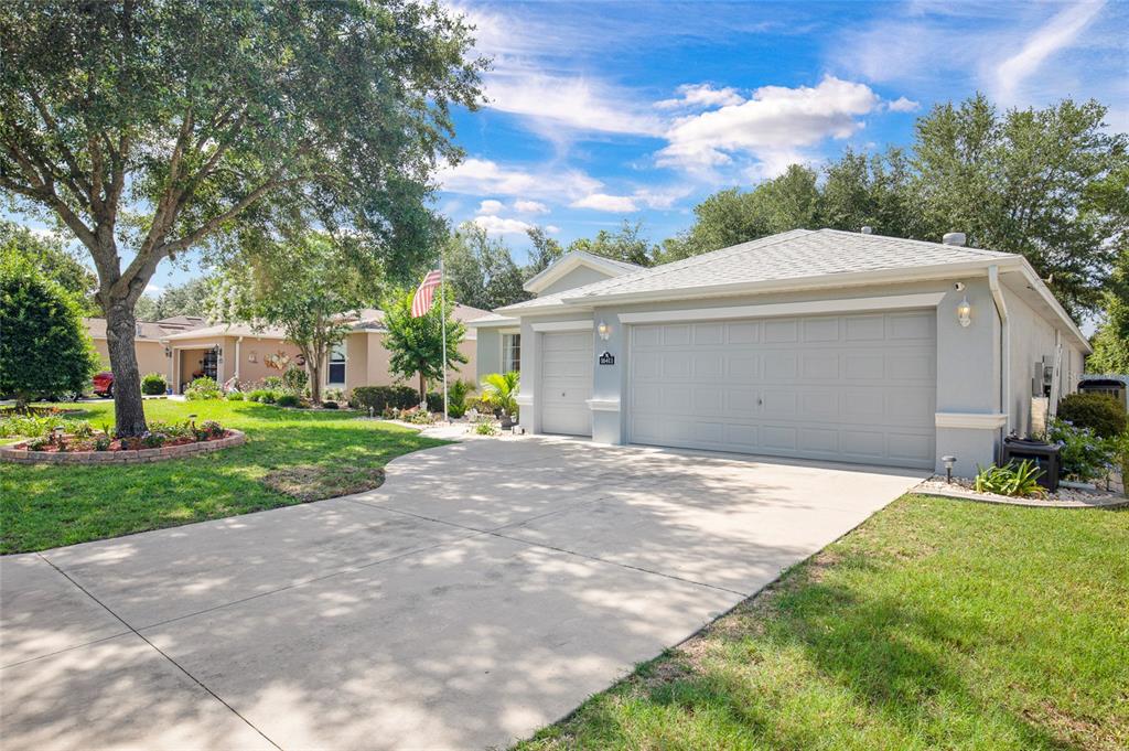 16411 Southwest 14th Avenue Road Ocala, FL 34473 - Photo 53 of 59 a front view of a house with a yard and garage
