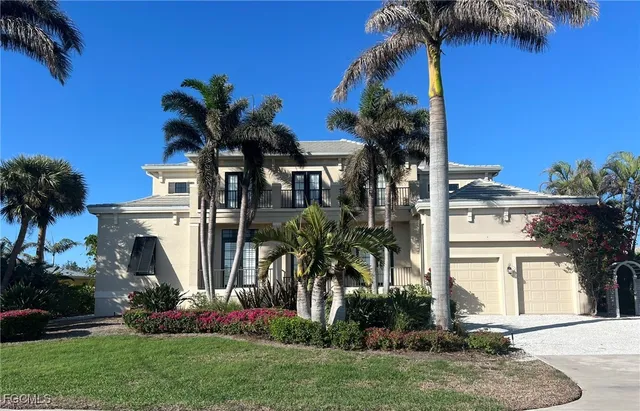 a front view of a house with a garden and yard