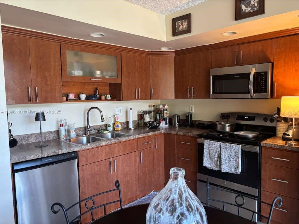 8400 Southwest 133rd Avenue Road, Unit 202 Miami, FL 33183 - Photo 13 of 23 a kitchen with stainless steel appliances granite countertop a sink stove and microwave