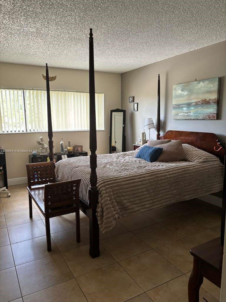 8400 Southwest 133rd Avenue Road, Unit 202 Miami, FL 33183 - Photo 14 of 23 a bedroom with a bed and a table