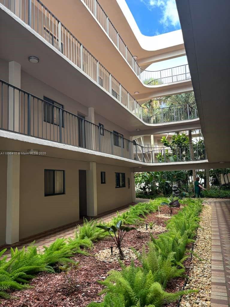 8400 Southwest 133rd Avenue Road, Unit 202 Miami, FL 33183 - Photo 4 of 23 a view of a building with a yard