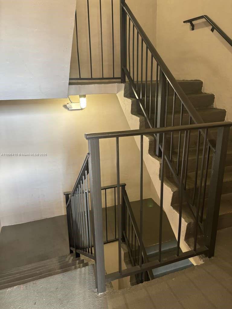8400 Southwest 133rd Avenue Road, Unit 202 Miami, FL 33183 - Photo 6 of 23 a view of staircase with railing and white walls