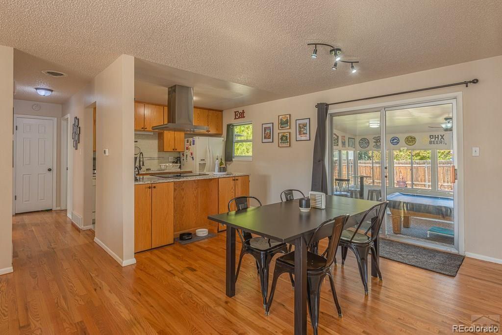 49 Calhoun Road Pueblo, CO 81001 - Photo 10 of 24 a view of a dining room with furniture and wooden floor