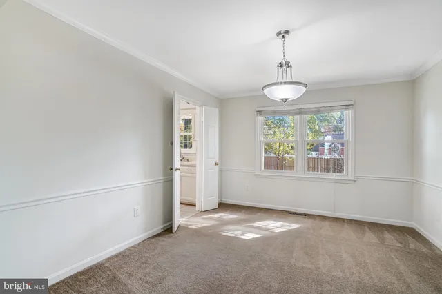 a view of a kitchen cabinets and refrigerator