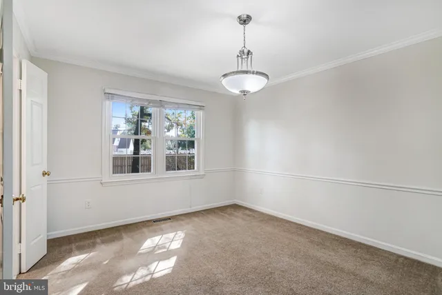 a view of a hallway with a chandelier fan and livingroom