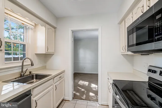 a kitchen with stainless steel appliances a sink and cabinets