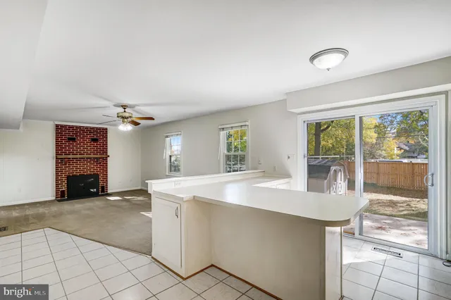 a room with a white cabinets and chandelier