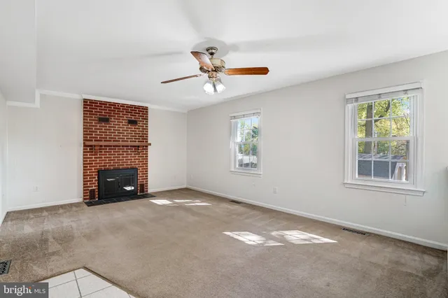 a view of an empty room with a fireplace
