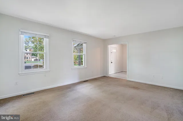 an empty room with windows and entrance