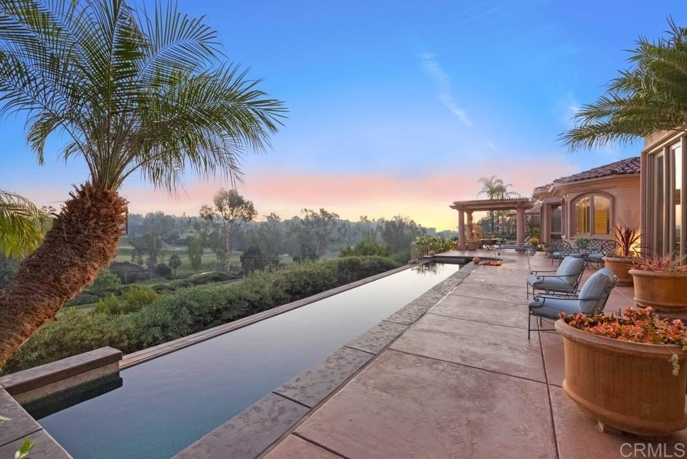 a view of a terrace with a garden and bench