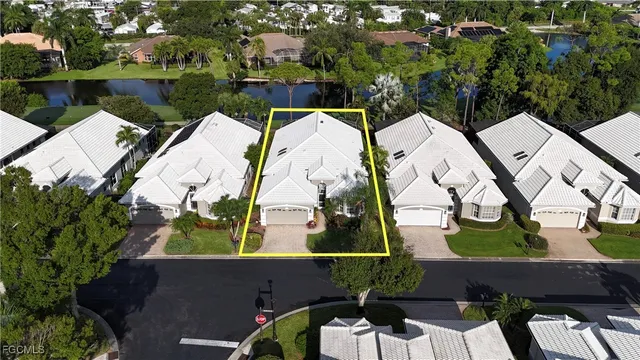 an aerial view of a house with a yard and lake view