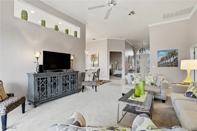 a living room with furniture and a floor to ceiling window