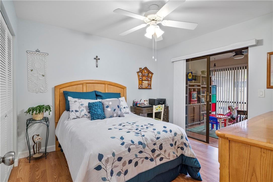 8046 Summerview Terrace Boca Raton, FL 33496 - Photo 14 of 25 a bedroom with a bed and a chandelier