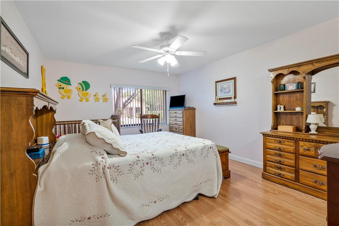 8046 Summerview Terrace Boca Raton, FL 33496 - Photo 16 of 25 a bed room with a bed and a flat screen tv